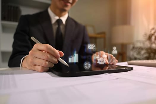 Businessman using digital tablet analyzing market trends with technology in modern business.