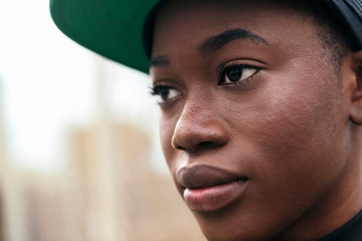 close up portrait of a cool african american young woman wearing a cap, copy space for text