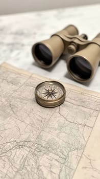 A vintage compass and binoculars on a map, evoking a sense of exploration and adventure.