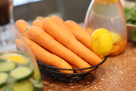 A beautifully vibrant arrangement of fresh, crunchy carrots and a zesty lemon, ideal for healthy cooking and meals