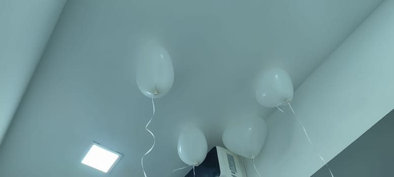 white heart shaped balloons hanging from ceiling, holiday objects. High quality photo