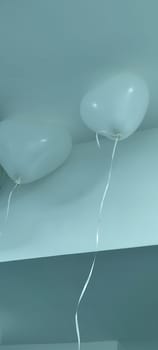 white heart shaped balloons hanging from ceiling, holiday objects. High quality photo