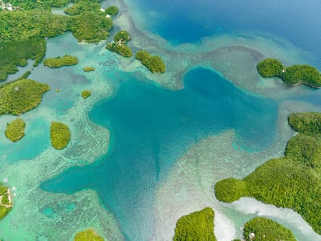 Aerial drone of tropical islands in a beautiful bay with turquoise water and lagoon. Sipalay, Negros, Philippines.