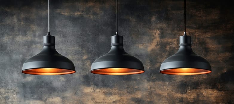 Three black ceiling lamps with copper inside illuminating a dark background, creating a warm and inviting atmosphere
