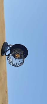 lamp lantern hanging on wall blue sky object electricity. High quality photo