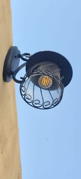 lamp lantern hanging on wall blue sky object electricity. High quality photo