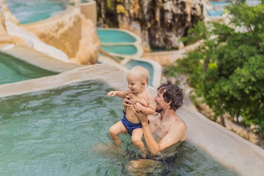 Father with his toddler son bathing in the hot springs of Grutas Tolantongo, Mexico. Family adventure, relaxation, and natural wellness concept.