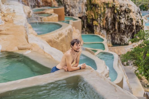 Male tourist at the hot springs of Grutas Tolantongo, Mexico. Adventure, relaxation, and natural wellness concept.