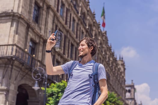 Male tourist in the central square of Mexico City, Zocalo. Cultural exploration, travel, and historic architecture concept.