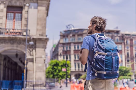 Male tourist in the central square of Mexico City, Zocalo. Cultural exploration, travel, and historic architecture concept.