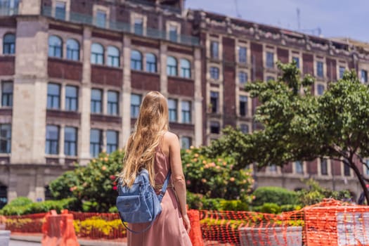 Female tourist in the central square of Mexico City, Zocalo. Cultural exploration, travel, and historic architecture concept.
