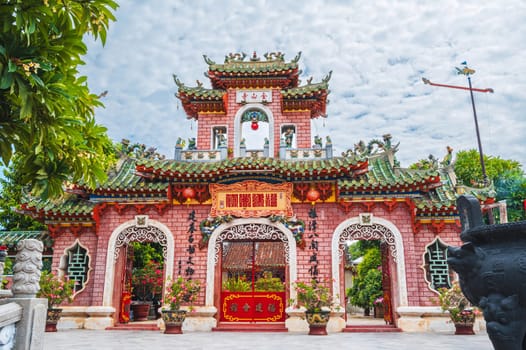 ancient red Asian gate to the Hoi Quan Phu Kien Buddhist pagoda in the old town in Hoi An in Vietnam in Asia