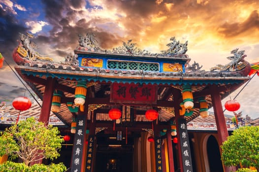 Beautiful ancient Asian Buddhist temple on the Vietnamese pagoda in the old town in Hoi An in Vietnam in Asia at sunset in summer