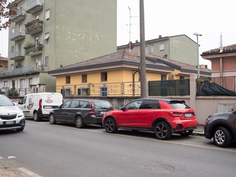 Cremona, Lombardy, Italy October 15th 2024 Parked cars lining a residential street in a typical italian town, showcasing everyday urban life