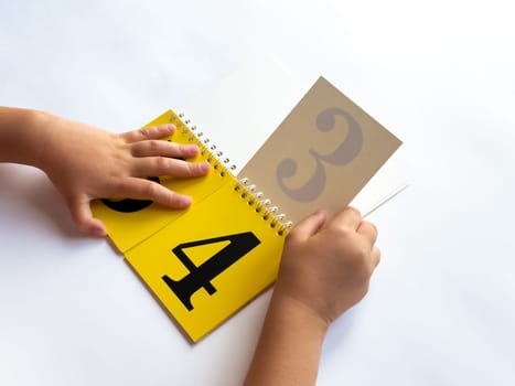 Child learning numbers with a colorful educational flip book.