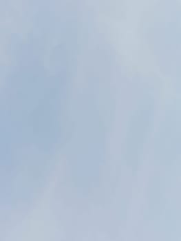 Serene image of a clear blue sky with soft clouds offers a tranquil and calming backdrop. Ideal for peaceful, nature-related themes and emphasizes simplicity and spaciousness.