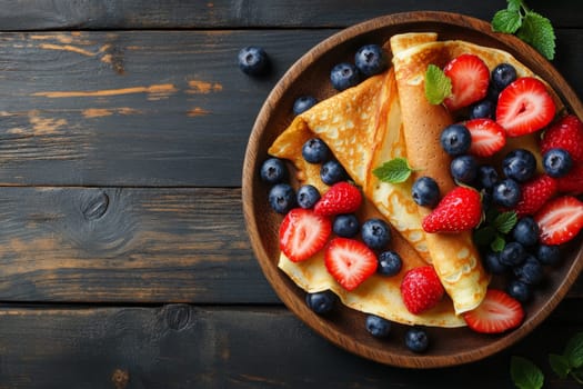 Hot delicious pancakes decorated with blueberries and strawberries. High quality photo
