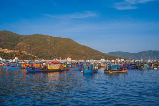 There are many traditional Vietnamese fishing boats and ships in the bay on the river at the Vinh Truong fishing port in Nha Trang. Nha Trang, Vietnam - September 8, 2024