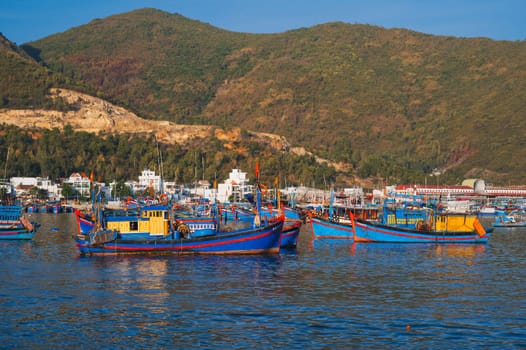 Traditional Vietnamese fishing boats and ships in the harbor at sea at the fishing port in Nha Trang. Nha Trang, Vietnam - September 8, 2024