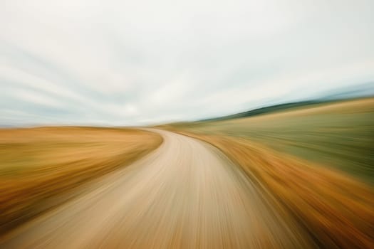 Captured in motion, this abstract image features a blurred road leading into a serene horizon, evoking a sense of speed and adventure in nature.