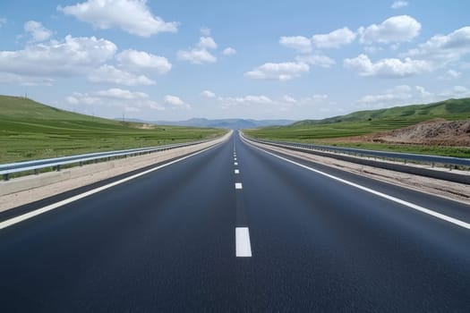 A blurred view of a straight racing road extending into the horizon. The vibrant landscape features clear blue skies and green fields, suggesting freedom and adventure.