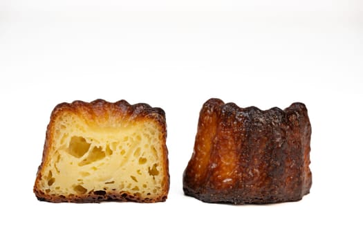 Caneles de bordeaux, traditional French sweet dessert with white table background, High quality photo