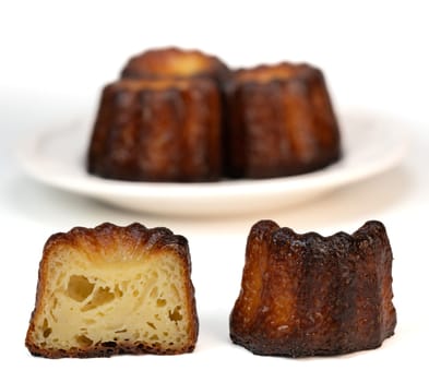 Caneles de bordeaux, traditional French sweet dessert with white table background, High quality photo