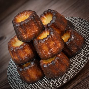 Caneles de bordeaux, traditional French sweet dessert with white table background, High quality photo