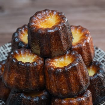 Caneles de bordeaux, traditional French sweet dessert with white table background, High quality photo