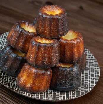 Caneles de bordeaux, traditional French sweet dessert with white table background, High quality photo