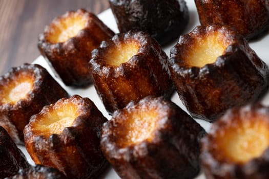 Caneles de bordeaux, traditional French sweet dessert with white table background, High quality photo