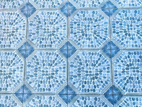 Beautifully arranged pebble-patterned tiles in soft blue tones create a serene backdrop with plenty of room for additional text.