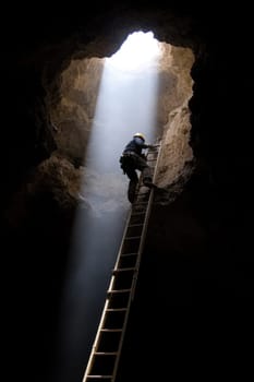 Life beneath earth: a mine worker focused on excavation in a subterranean environment showcasing the hard work, persistence, and skill involved in the mining profession