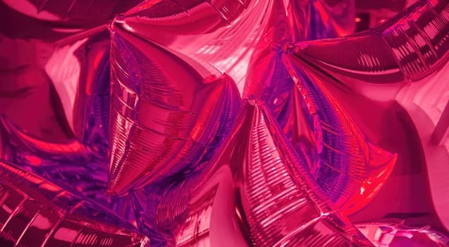 A collection of shiny pink metallic balloons fills the frame, creating a festive atmosphere ideal for celebrations, parties, or special occasions, reflecting light beautifully.