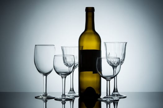 A display of empty wine glasses and a wine bottle.
