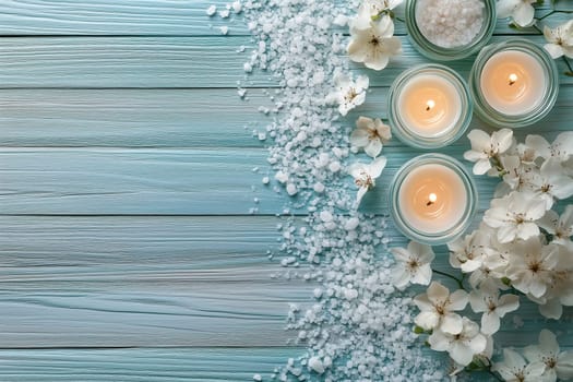 A serene spa setup features lit candles, delicate flowers, and coarse salt arranged on a wooden table. Soft natural light enhances the tranquil atmosphere.
