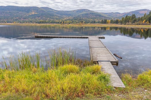 Looking out at the dockon the calm McArthur Lake in north Idaho.