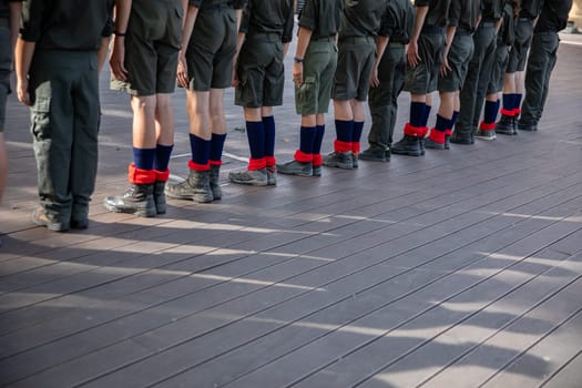 Cadets dressed in their formal uniforms are standing in a straight line, showcasing discipline and strong teamwork