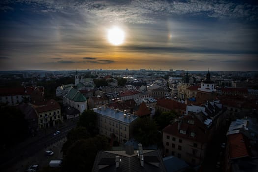 A captivating and breathtaking sunset brilliantly illuminates an intricate cityscape featuring historical architecture