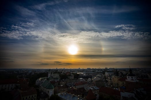 A breathtaking and mesmerizing sunset view over a vibrant city skyline, adorned with clouds and soft lighting
