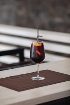A glass of fresh delicious sangria on the table in the restaurant.