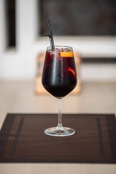 A glass of fresh delicious sangria on the table in the restaurant.