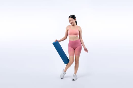 Young attractive asian woman portrait in sportswear with exercising mat. Healthy exercise and workout routine lifestyle concept. Studio shot isolated background. Vigorous