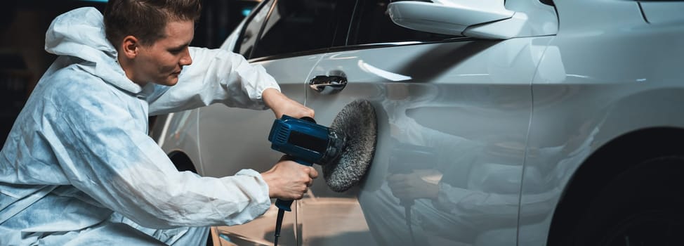 Automotive repair shop, concept of car detailing and polishing by professional car service worker with precision using orbital polisher machine creative captivating automotive flourish . Panorama Oxus