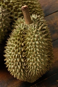 Mon Thong durian fruit on wooden plank background. Regarded by many people in southeast asia as the king of fruits.