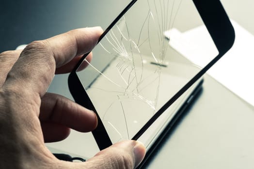 closeup broken tempered glass screen protector for smartphone.