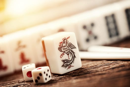 Many old mahjong tiles on wooden table. Mahjong is the ancient asian board game.