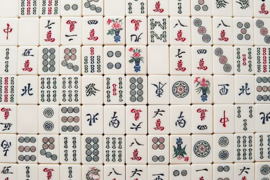 Many old mahjong tiles on wooden table. Mahjong is the ancient asian board game.
