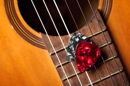 Closeup guitar pick on an old classical guitar. A guitar pick is a plectrum used for guitars.