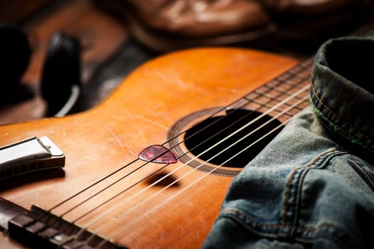 Closeup guitar pick on an old classical guitar. A guitar pick is a plectrum used for guitars.